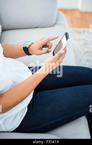 Midsection of woman using smart phone Stock Photo