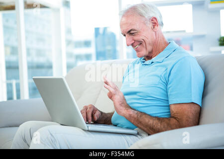 Side view of senior man using laptop Stock Photo
