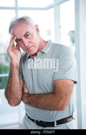 Portrait of tensed man touching his head Stock Photo