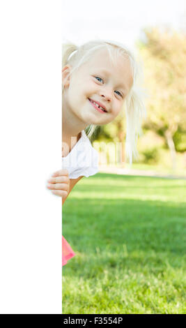 Cute Little Girl Outside Holding Edge of White Board with Room For Text. Stock Photo