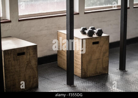 Two dumbbells near each other on a box Stock Photo