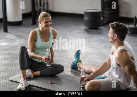 Sitting young couple drinking water Stock Photo