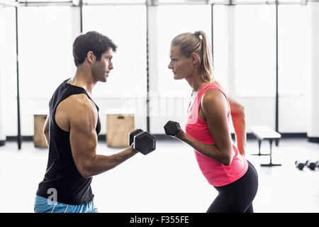 Sporty couple exercising with dumbbells Stock Photo