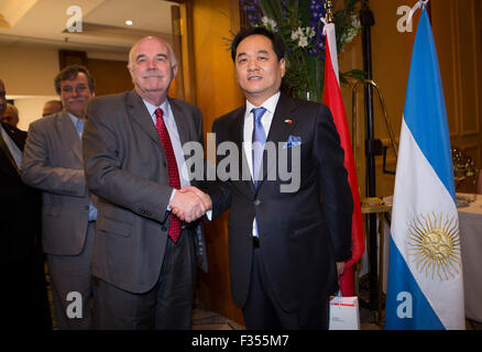 Buenos Aires, Argentina. 29th Sep, 2015. China's Ambassador to Argentina Yang Wanmin (R) greets Argentine Agriculture Minister Carlos Casamiquela during a reception for the 66th anniversary of the founding of the People's Republic of China in Buenos Aires, capital of Argentina, on Sept. 29, 2015. Credit:  Martin Zabala/Xinhua/Alamy Live News Stock Photo