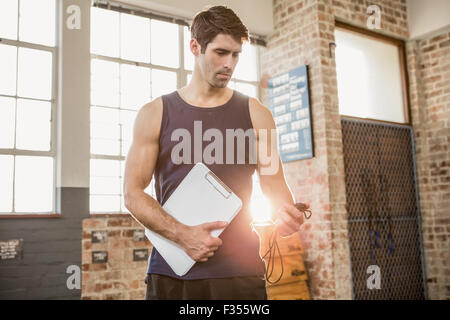 Instructor holding clipboard and stopwatch Stock Photo