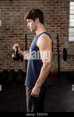 Side view of man lifting kettlebell Stock Photo