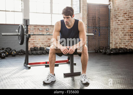 Serious man sitting on bench Stock Photo