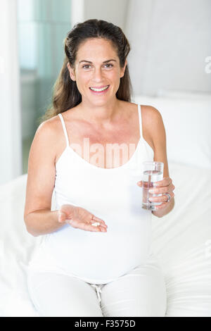 Portrait of happy woman with pills Stock Photo