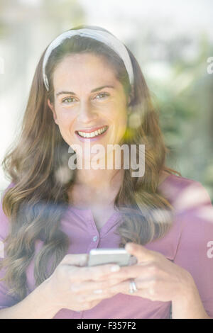 Portrait of happy woman with smartphone Stock Photo