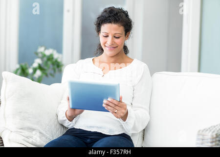 Happy woman using tablet computer Stock Photo