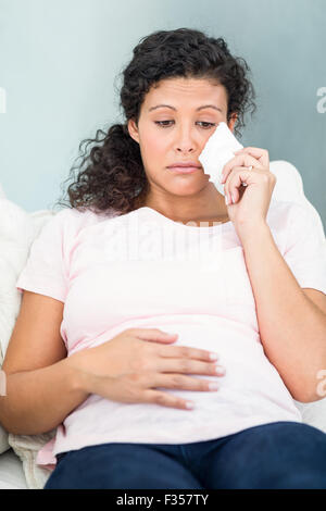 Unhappy woman with tissue crying Stock Photo