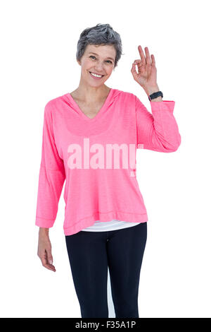 Portrait of cheerful mature woman showing OK sign Stock Photo