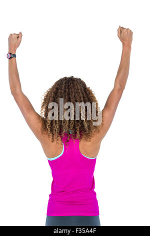 Rear view of young woman cheering with arms raised Stock Photo - Alamy
