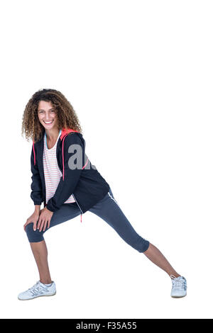 Portrait of happy young woman stretching Stock Photo