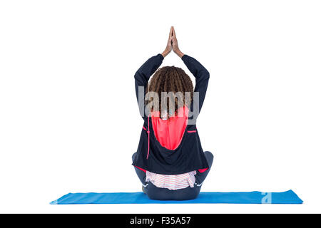 Rear view of young woman practicing yoga tree pose on beach, Dominican ...