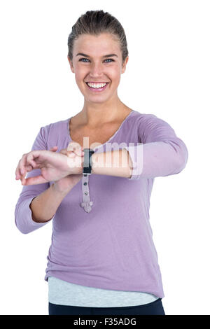 Portrait of happy young woman wearing wristwatch Stock Photo