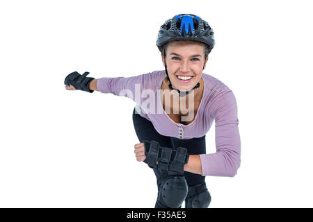 Portrait of cheerful young woman skating Stock Photo