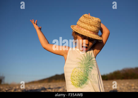 Cute little girl emotional outdoor portrait in warm light of sunset Stock Photo