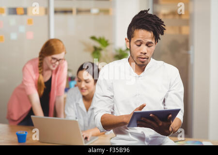 Businessman using digital tablet in office Stock Photo