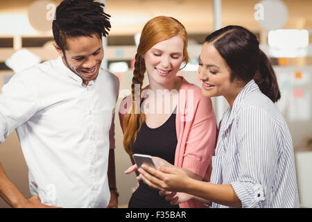 Colleagues looking at smart phone Stock Photo