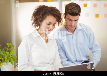 Business woman using digital tablet while male colleague Stock Photo