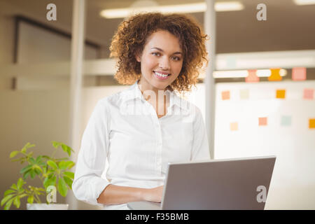 Smiling businesswoman using laptop Stock Photo