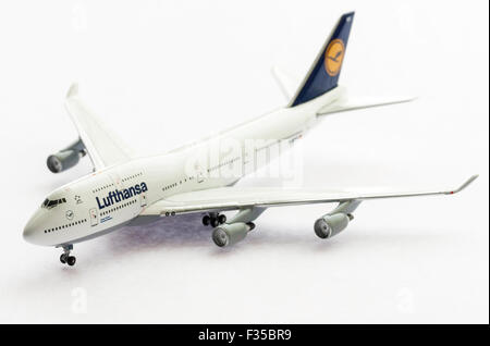 Close up of a die-cast 1/200 scale model of Lufthansa Boeing 747 jumbo jet on plain white background with some underlighting. Stock Photo