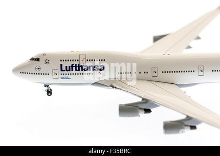 Close up of a die-cast 1/200 scale model of Lufthansa Boeing 747 jumbo jet on plain white background with some underlighting. Stock Photo