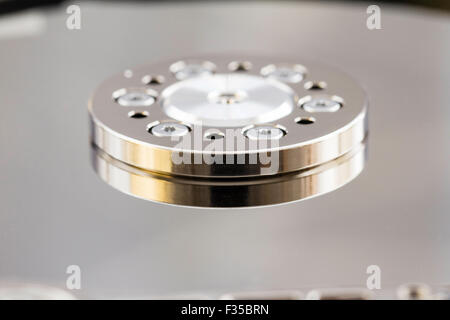 Computer hard disc drive. Inside showing the spindle that controls the turning of the patter, disc. Stock Photo