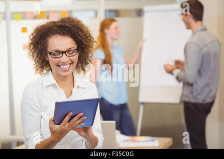 Businesswoman using digital tablet in office Stock Photo