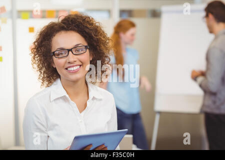 Portrait of businesswoman using digital tablet in office Stock Photo