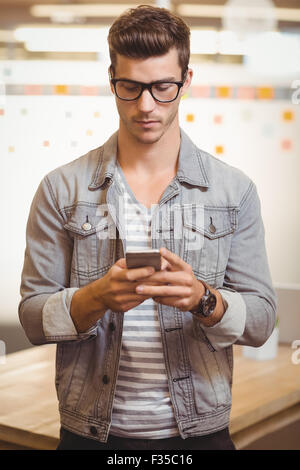 Businessman texting on phone Stock Photo