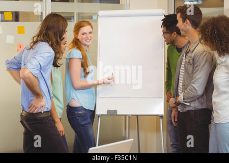 Smiling businesswoman discussing with colleagues Stock Photo