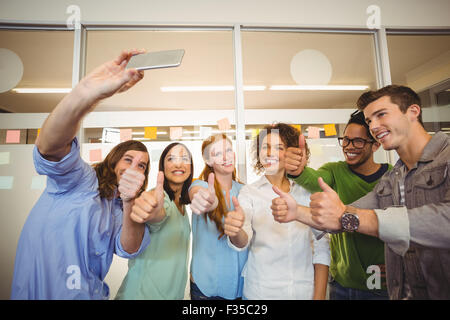 Business people taking selfie with thumbs up Stock Photo