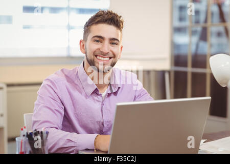 Portrait of businessman working on laptop Stock Photo