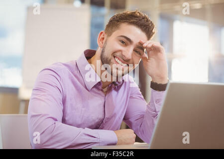 Smiling businessman working with laptop Stock Photo
