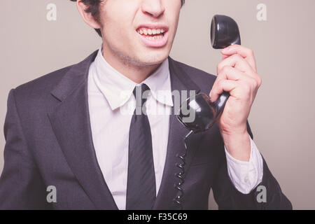 Young businessman can't believe what he is hearing on the phone Stock Photo