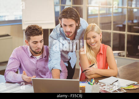 High angle view of businessman using laptop while colleagues Stock Photo