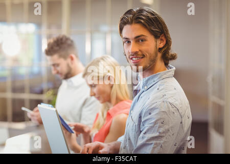 Businessman with colleagues working in office Stock Photo