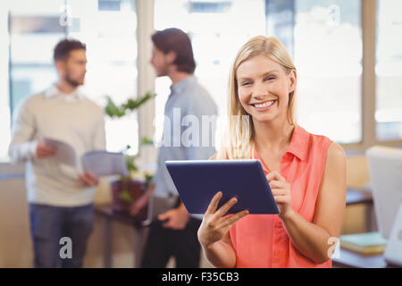 Smiling businesswoman using digital PC Stock Photo
