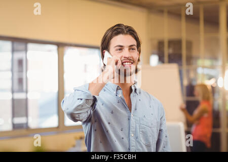 Confident businessman talking on phone Stock Photo