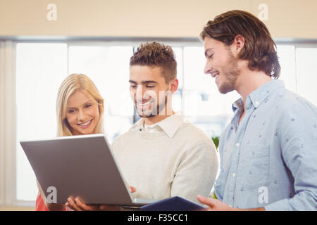 Young business people using laptop in a city park Stock Photo - Alamy