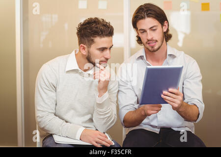 Businessman showing digital tablet Stock Photo