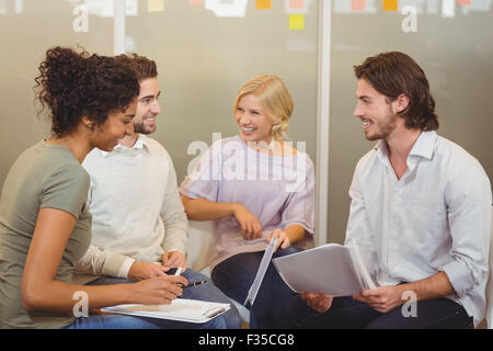 Colleagues interacting with each other Stock Photo