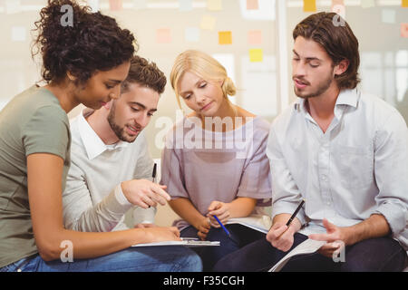 Colleagues interacting with each other Stock Photo