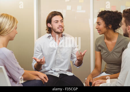 Businessman talking to colleagues Stock Photo