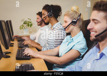 Smiling executives working in call center Stock Photo
