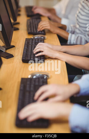Cropped hands of executives on keyboard in office Stock Photo