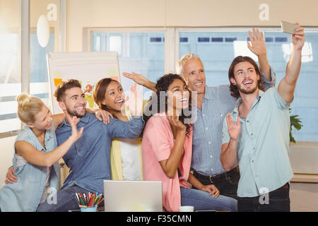 Business people taking selfie in meeting room Stock Photo