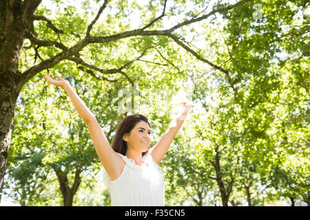 Happy woman with arms raised Stock Photo